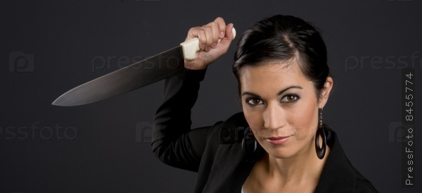 Pretty Brunette Woman aggressive attacking ready to stab you with large kitchen knife blade