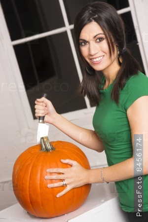 Woman preps Pumpkin for Halloween Jack o Lantern