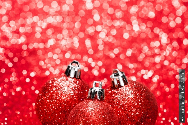 Beautiful red christmas balls on abstract glitter background close-up