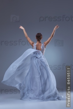 The beautiful ballerina dancing in blue long dress