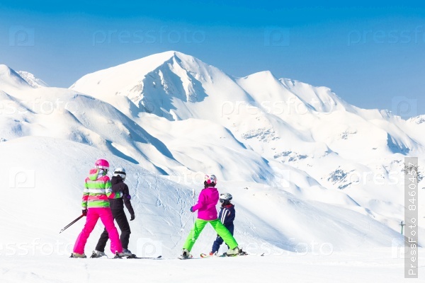Family on winter ski vacations in ski slopes in Alps, Vogel, Slovenia, Europe, stock photo
