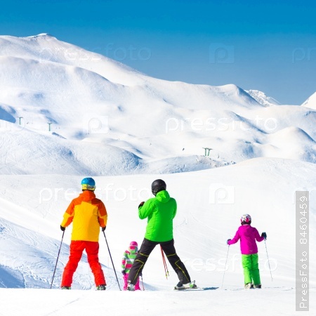 Family on winter ski vacations in ski slopes in Alps, Vogel, Slovenia, Europe.