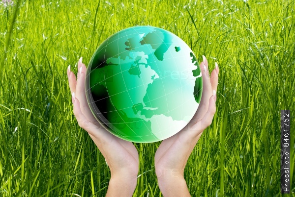 Globe Green Planet Earth in hands Woman on the fresh green grass background