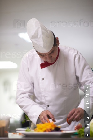 chef in hotel kitchen preparing and decorating food, delicious vegetables and meat  meal dinner