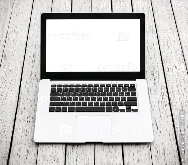 Open laptop with isolated screen on white wooden desk.