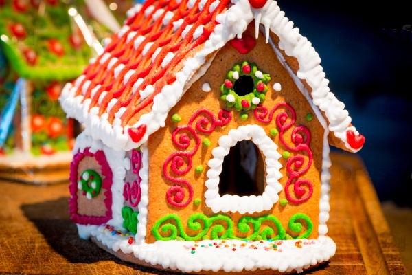 Lovely gingerbread house is beautifully decorated with glaze close-up, stock photo