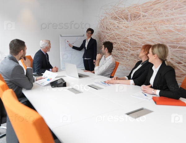 business people group on meeting at modern bright office indoors. Senior  businessman as leader in discussion.