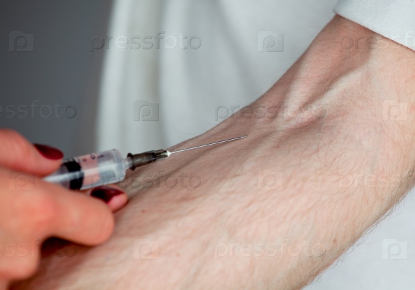 Intravenous injection by medical doctor to patient separately on the grey background