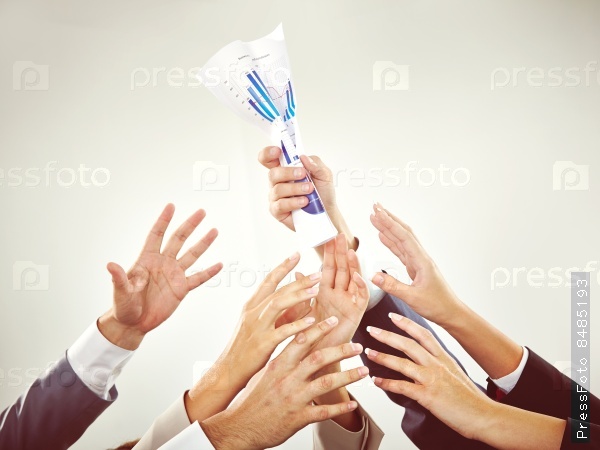 Hands of business people reaching for document in hand of colleague