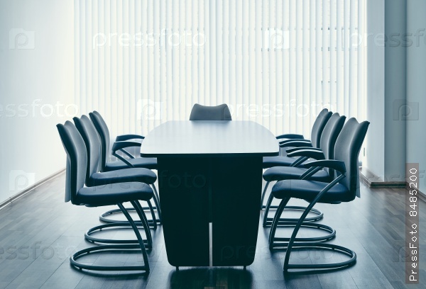 Empty office with table and chairs around it
