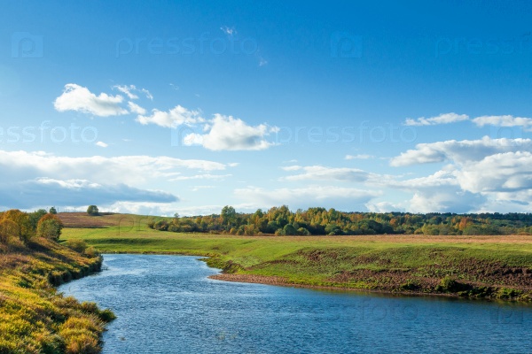 Autumn landscape with river on foreground.