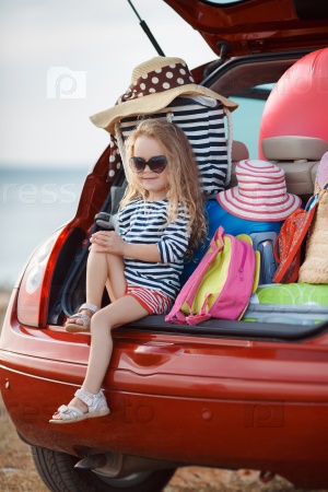 Vacation, Travel - family ready for the travel for summer vacation. suitcases and car with sea on background. girl with map in hands planning road trip. travel concept. traveler.