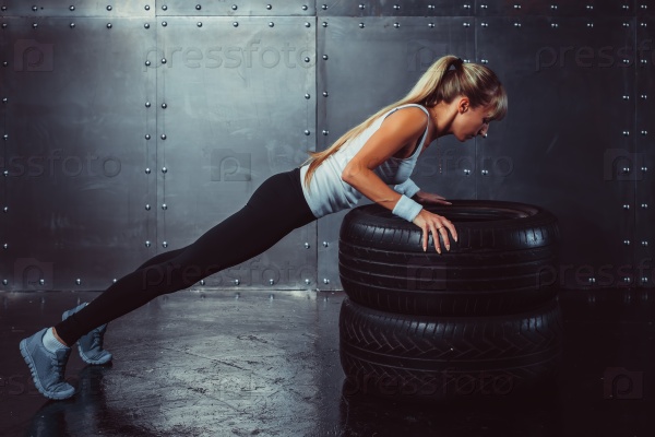 Beautiful fit woman works out in a fitness gym - Stock Image - Everypixel