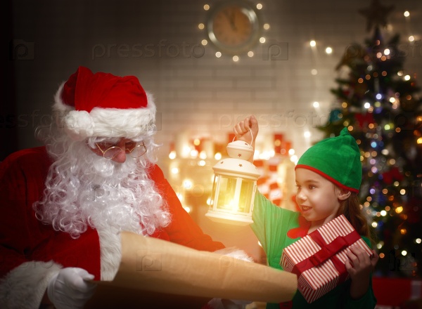 Сute elf helps Santa Claus reading wish list