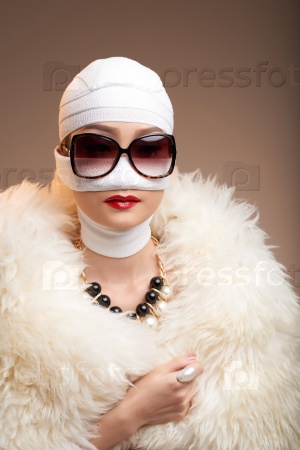 Woman in bandage wearing fur coat