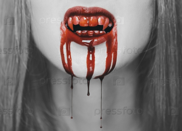Spooky vampire woman, close-up of mouth with teeth in red blood. Halloween or horror theme. Black and white image with red elements