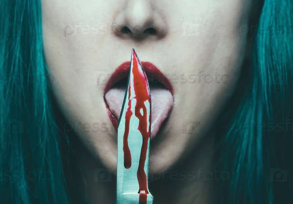 Dangerous woman licking knife with blood. Halloween or horror theme