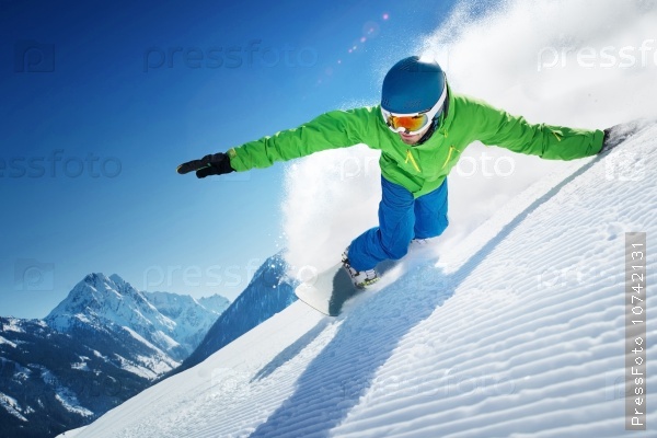 Snowboarder skiing in high mountains.