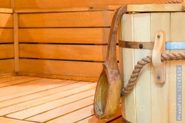 Wooden bucket and ladle in sauna close up, stock photo