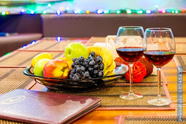 Menus and wine glasses on a table in a restaurant close up, stock photo