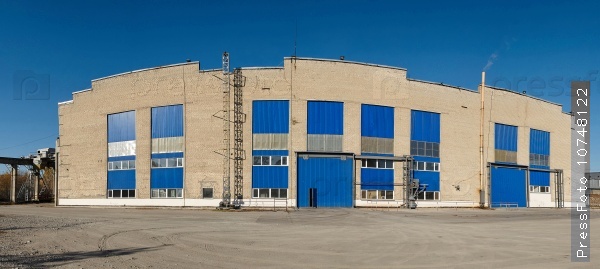 Facade of large industrial warehouse with aluminum panels