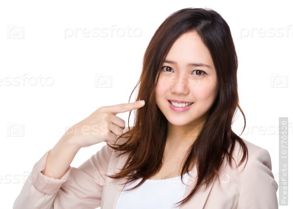Young businesswoman with finger point to her teeth