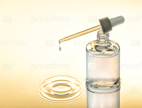 Moisturizing serum for dry skin, yellow background, pipette with drop, splash.