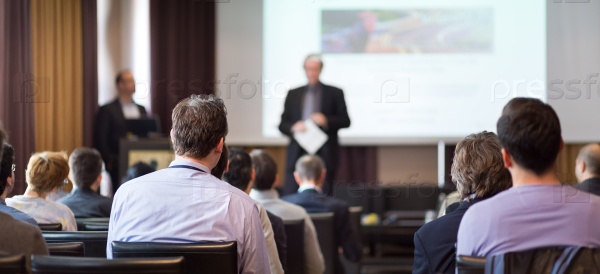 Speaker Giving a Talk at Business Meeting. Audience in the conference hall. Business and Entrepreneurship. Panoramic composition suitable for banners, stock photo
