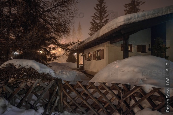 Mountain chalet in winter Alps in night lights, stock photo
