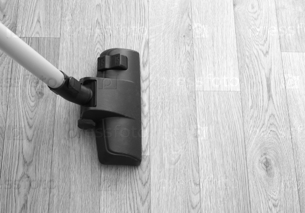 Vacuum cleaner on wooden floor