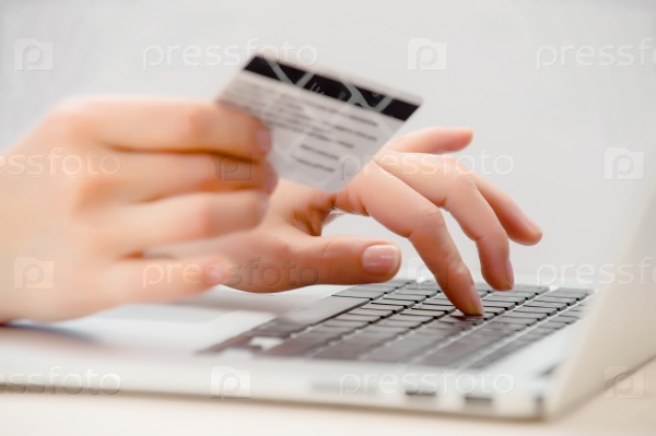 Hands holding credit card and using laptop. Online shopping, stock photo