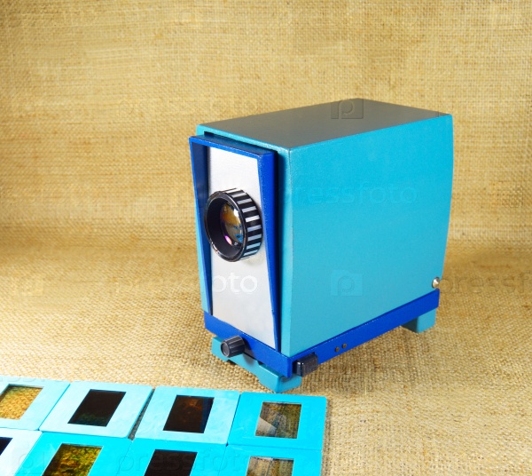 blue vintage slide projector and a slide films