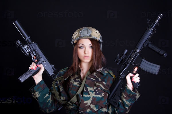 Portrait of a military woman with two guns over black background