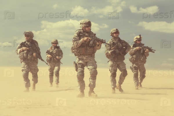 United States paratroopers airborne infantrymen in action in the desert, stock photo