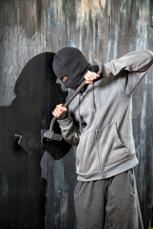 a burglar breaking open of a padlock metal door