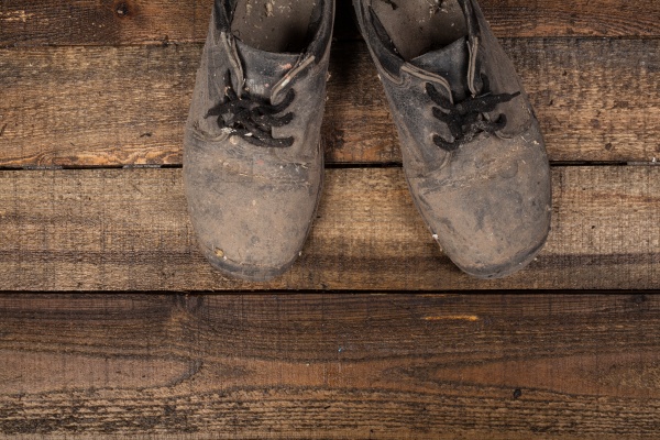 Grunge old boots on the wood background