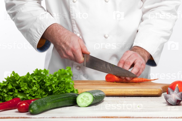 The chef cooking fresh vegetable salad in his kitchen on white background , stock photo