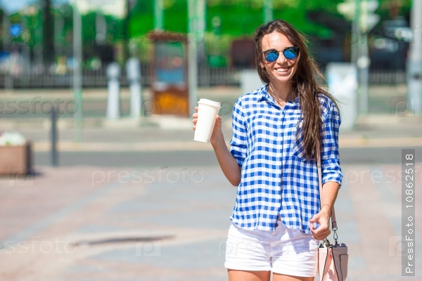 Young woman with glass of coffee outdoor