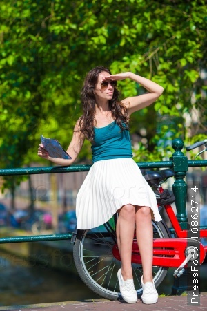 Young beautiful woman on bike in european city