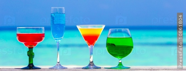 Colorful exotic tasty cocktails in outdoor cafe background turquoise sea at exotic resort