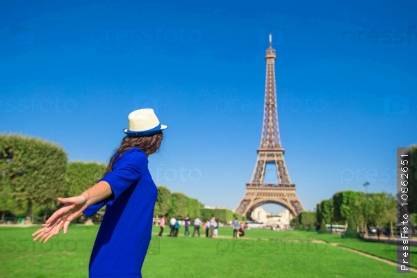 Young woman having fun background Eiffel Tower in Paris, stock photo