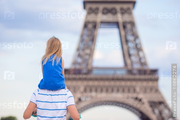 Beautiful happy family in Paris background Eiffel Tower. French summer holidays, travel and people concept.
