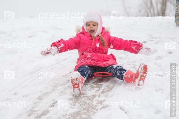 Girl closing her eyes and opening the ice kind of rolling hills, stock photo