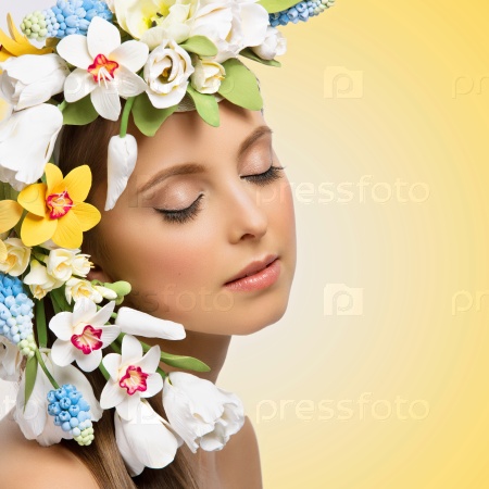 Closeup portrait of beautiful young woman with many flowers on head. Isolated over yellow background. Copy space, Square composition.