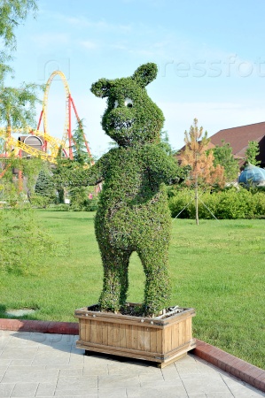 SOCHI, RUSSIA - JUNE 28, 2015: figure of a bear out of the bushes in popular Russian theme Park \