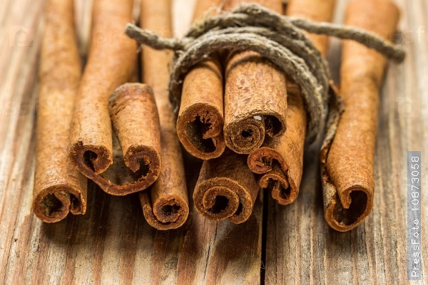 Cinnamon sticks on a wooden background