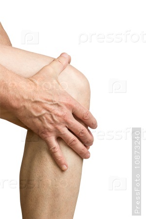 Pain in the knee. close up of male hands holding knee