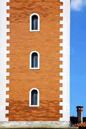 church   olgiate olona   italy the old wall terrace church window chimney and bell tower