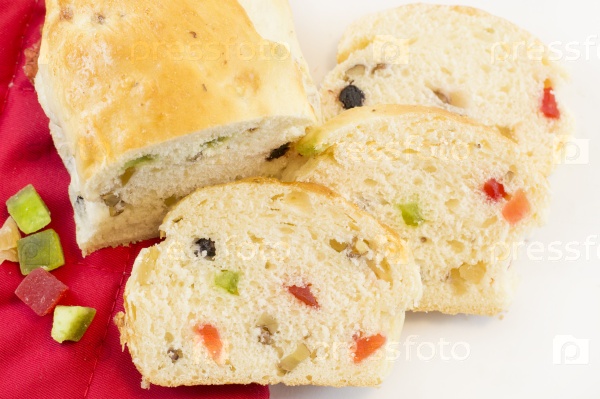 Homebaked colorful fruit bread with various dry fruits on white background
