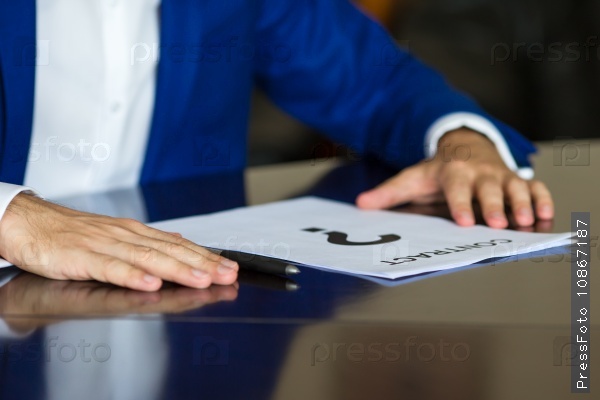 Close up of business person thinking on a contract paper, stock photo